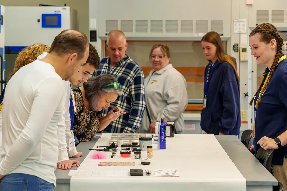 Visitors speak to a School of Pharmacy representative during a tour