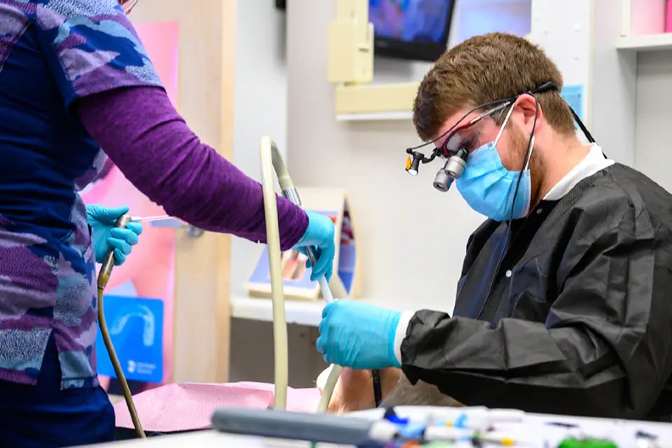 Dental student working with a patient