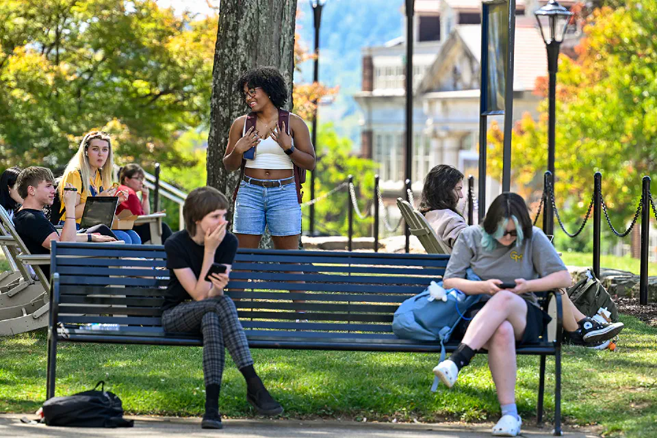 Students relaxing talking and relaxing in Woodburn Circle