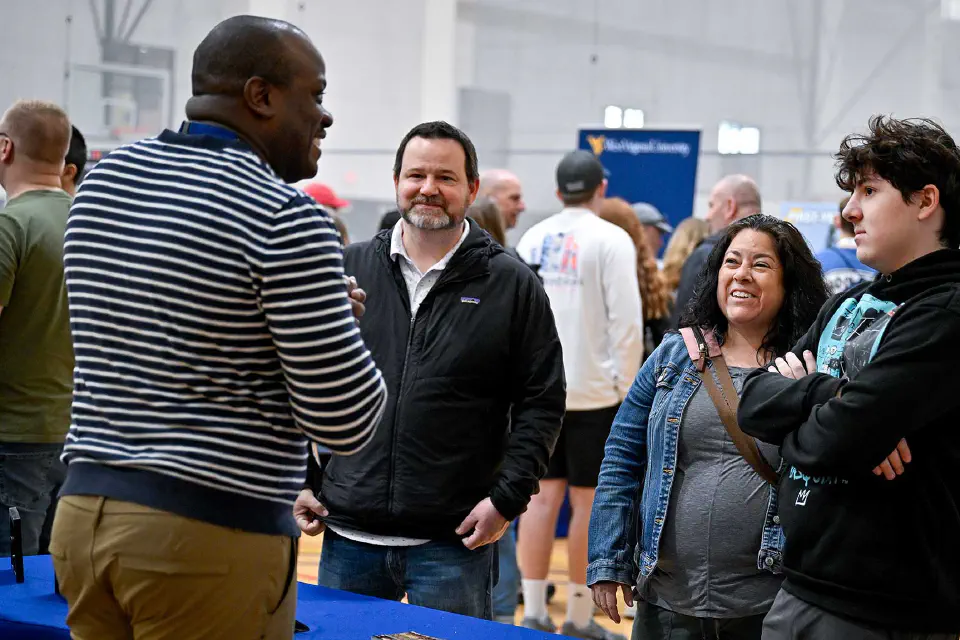 A family speaks with a School of Pharmacy representative