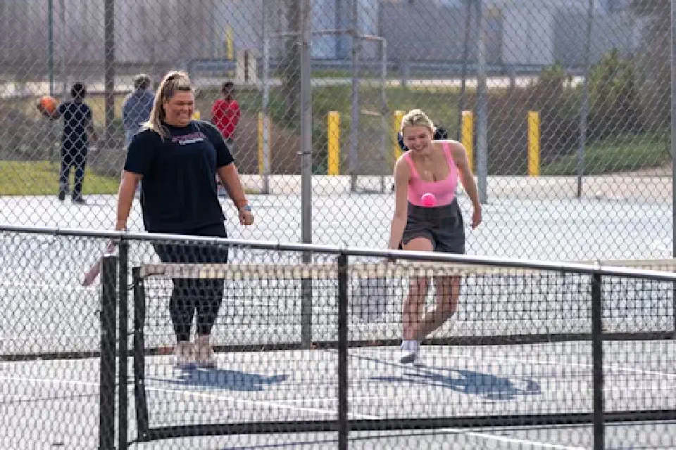 2 people playing Pickleball