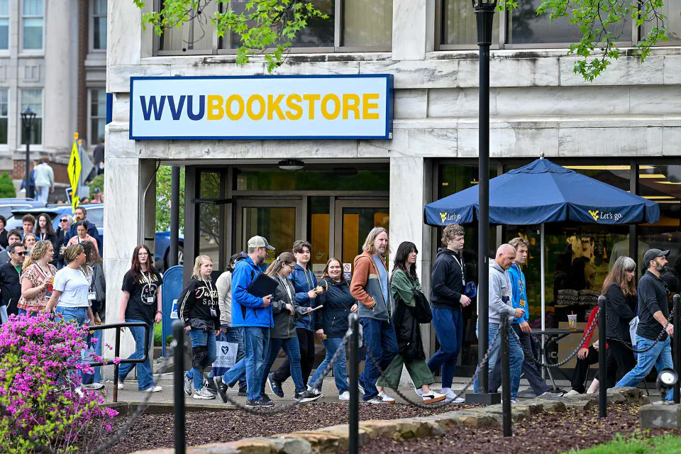 Tour group passes by the Downtown WVU Bookstore